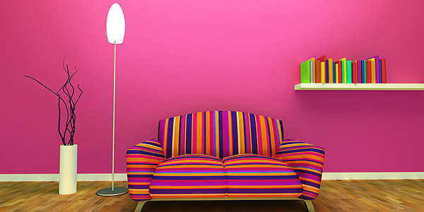 Hot pink painted room, with stripy couch