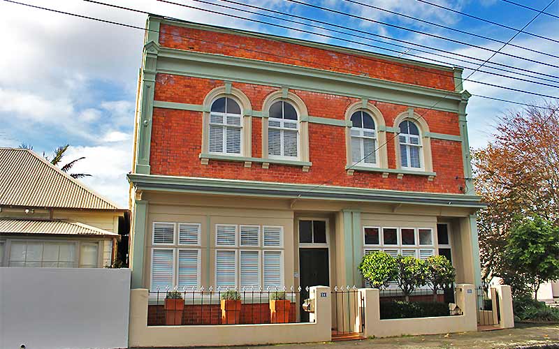 A two-story brick house in Auckland suburb of Devonport