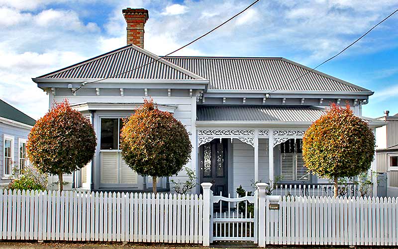 A nicely restored villa, with double-hung sash windows and decorative verandah.