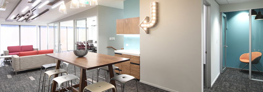 Office with red couch and arrow shaped marquee lights